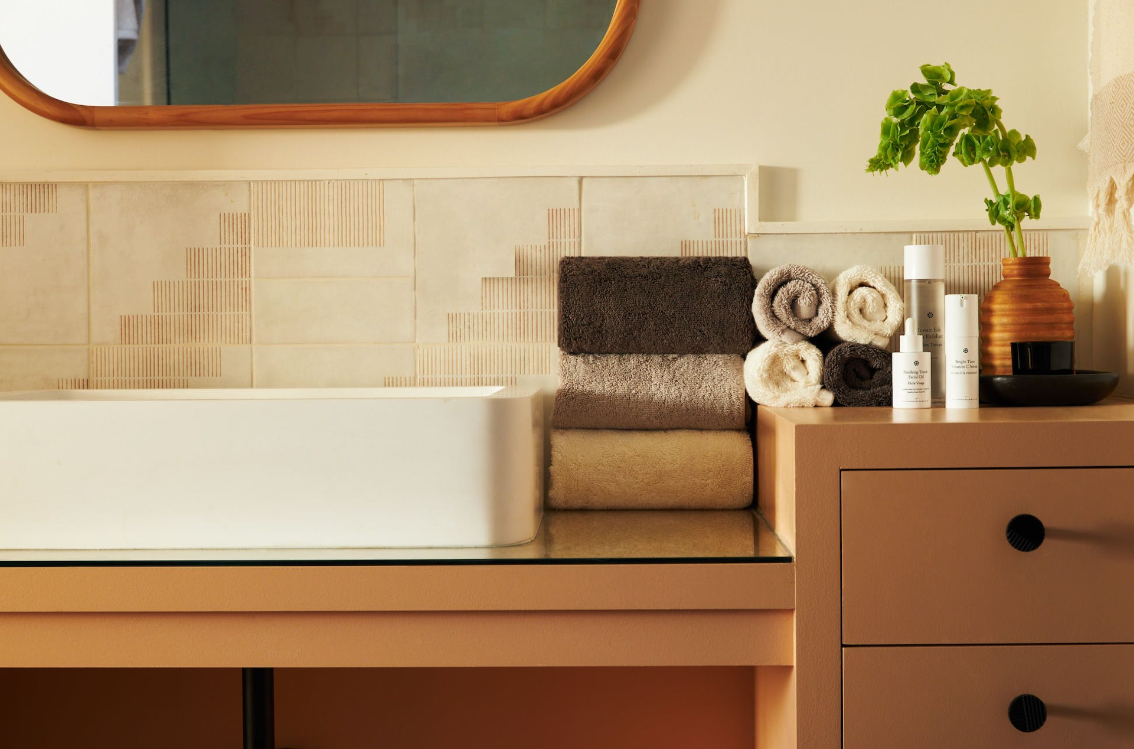 a bathroom with a sink and towels on the counter