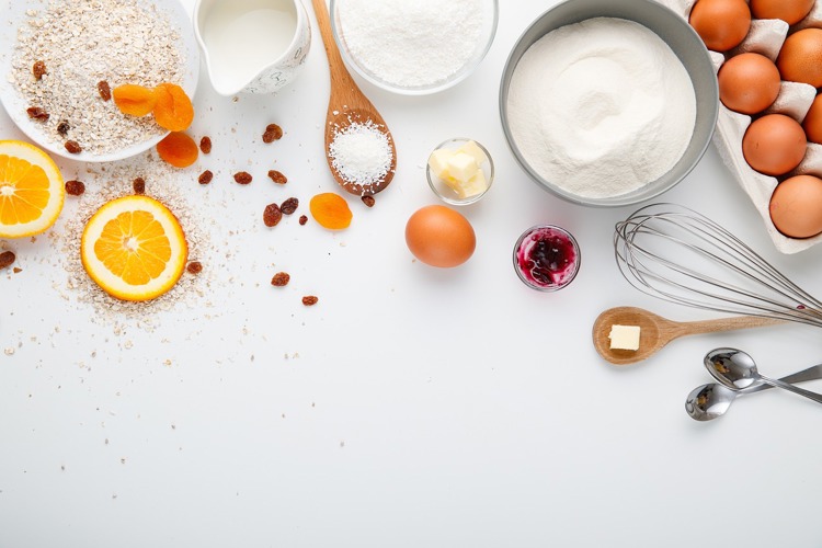 ingredients for baking are laid out on a white surface