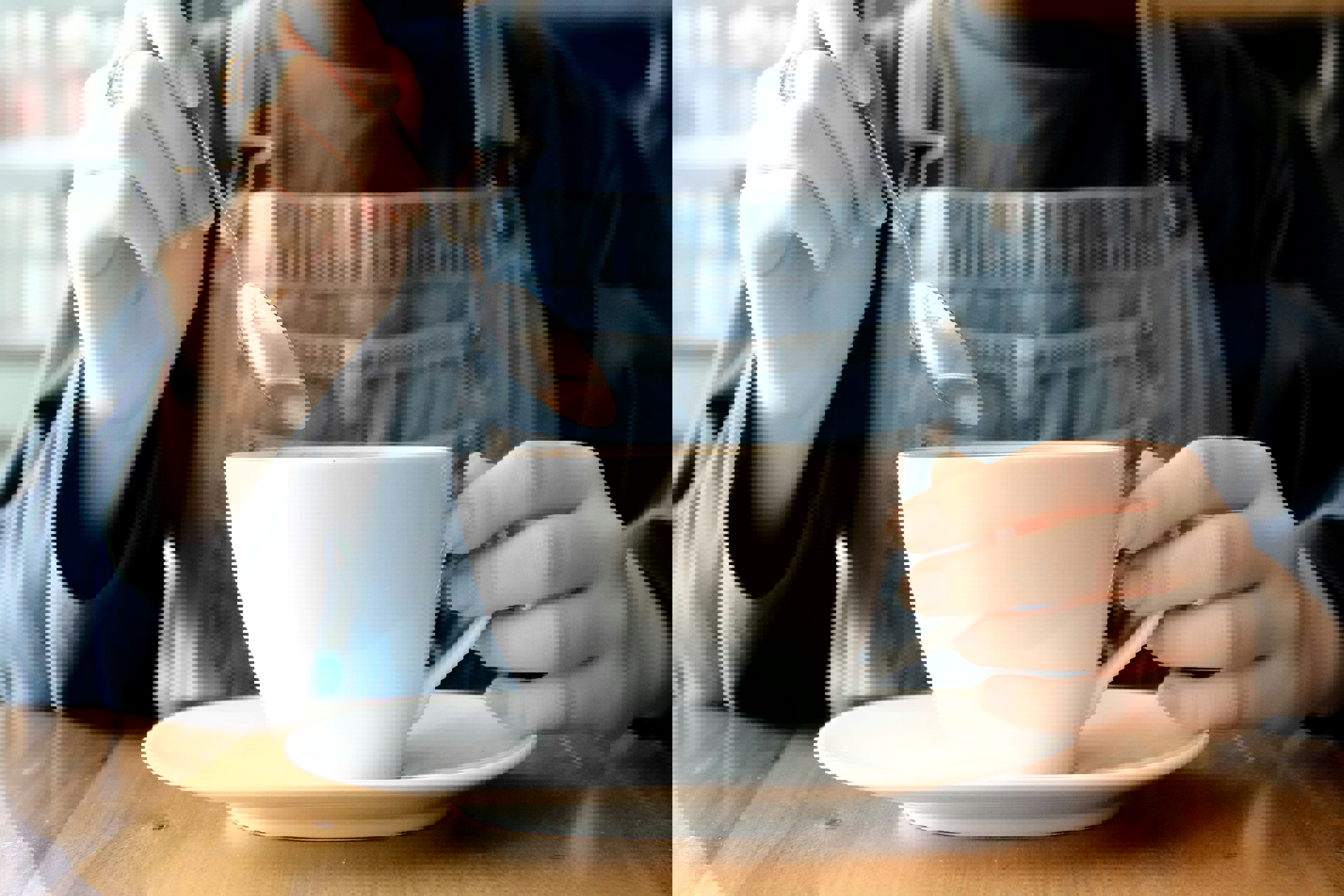 a person is stirring a cup of coffee with a spoon