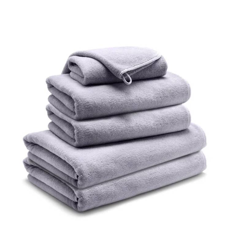 a stack of gray towels stacked on top of each other on a white background