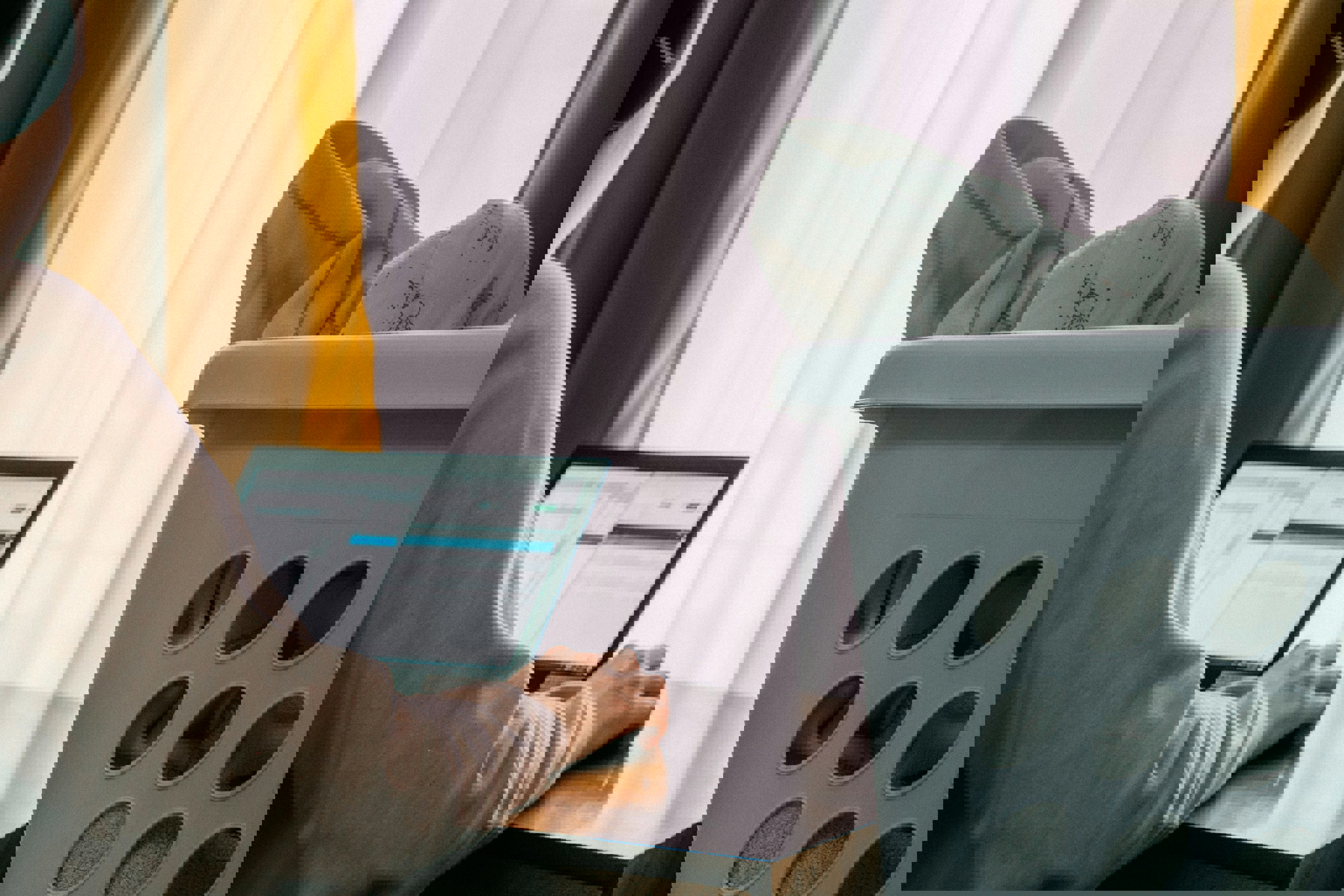 a person wearing bose headphones sits in front of a laptop