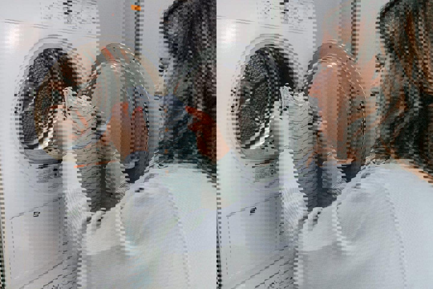 a woman is putting clothes in a washing machine