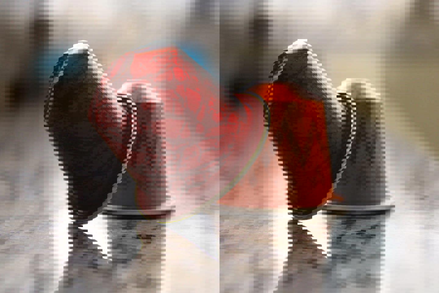 two coffee pods one red and one orange are on a counter