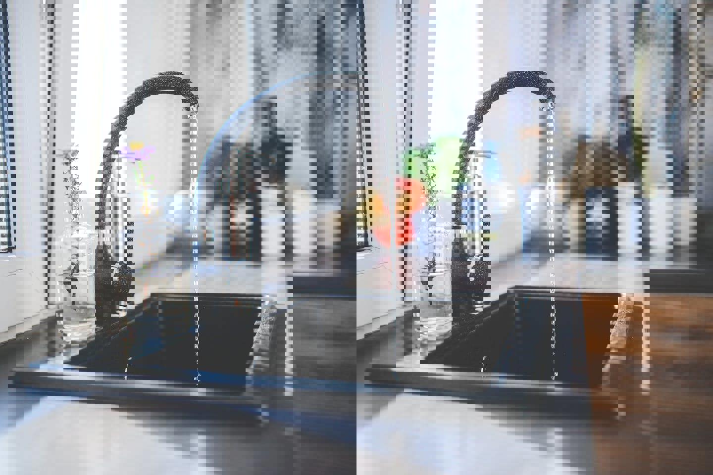 a kitchen sink with water running from the faucet