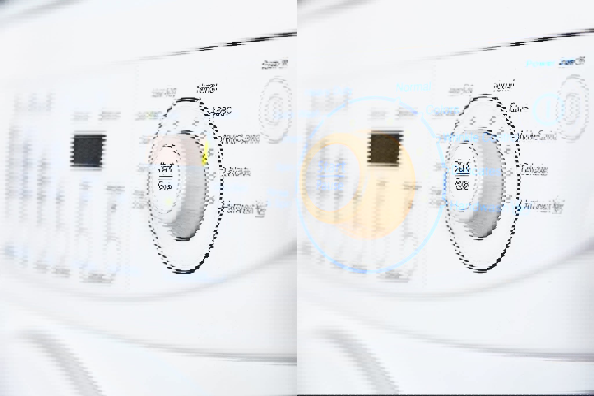 a white washing machine has a start pause button