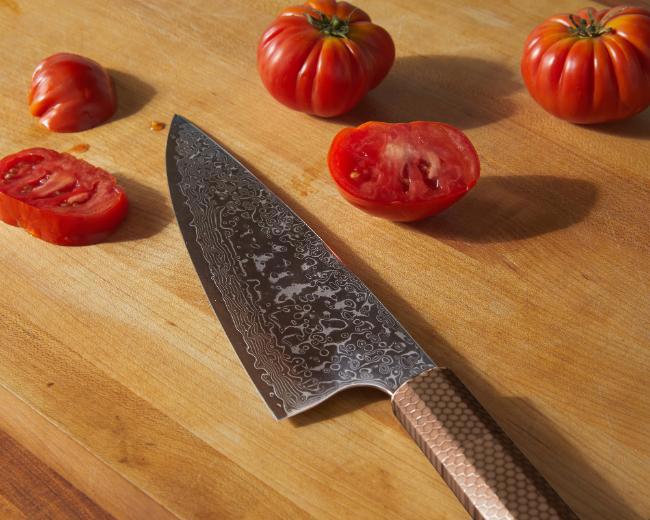 Knife, cut tomatoes on a cutting board