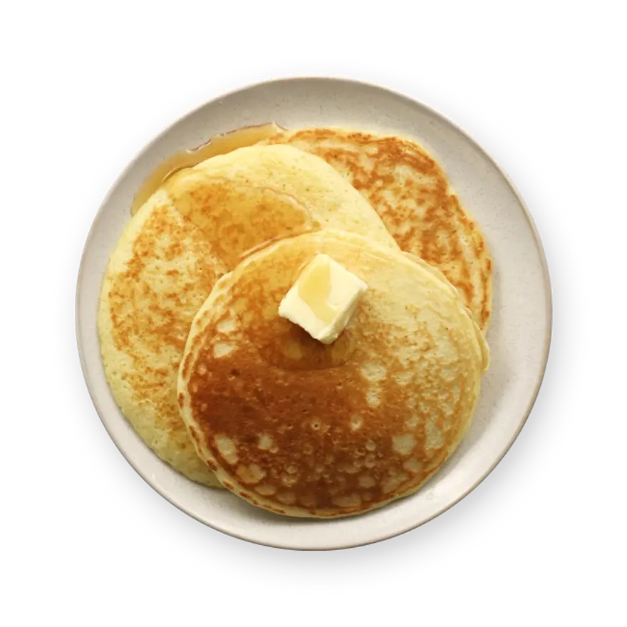 a plate of pancakes with syrup and butter on a black background