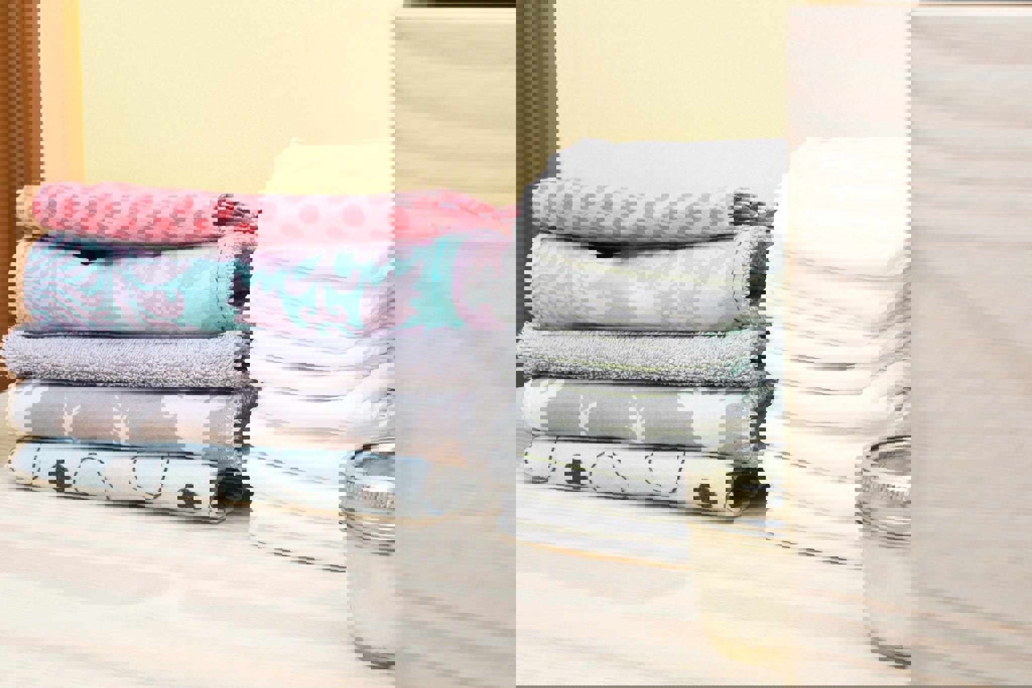 a stack of towels next to a stack of diapers