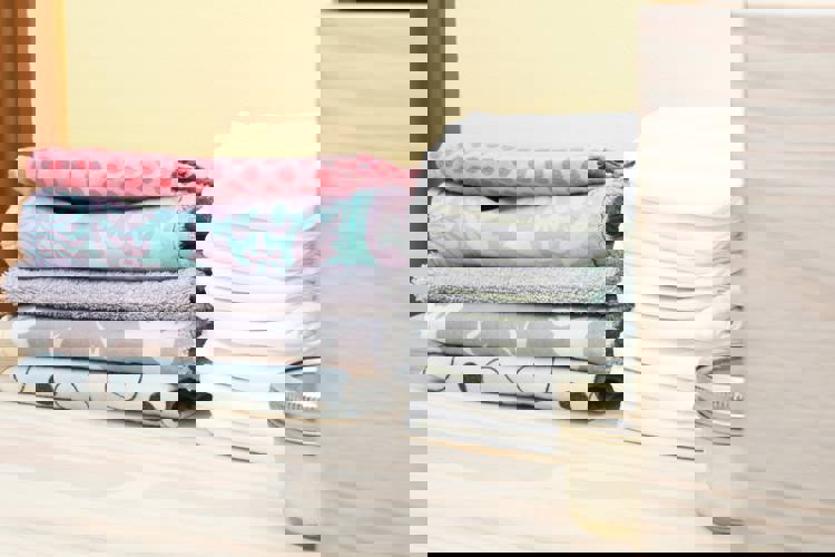 a stack of towels next to a stack of diapers