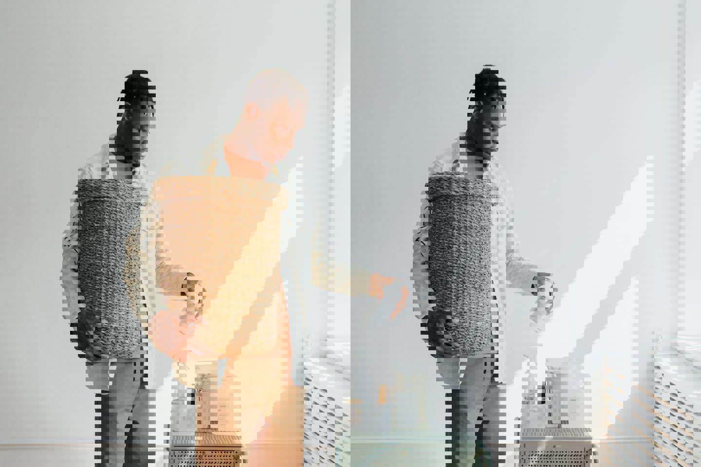 a man is holding a wicker basket and pouring liquid into it