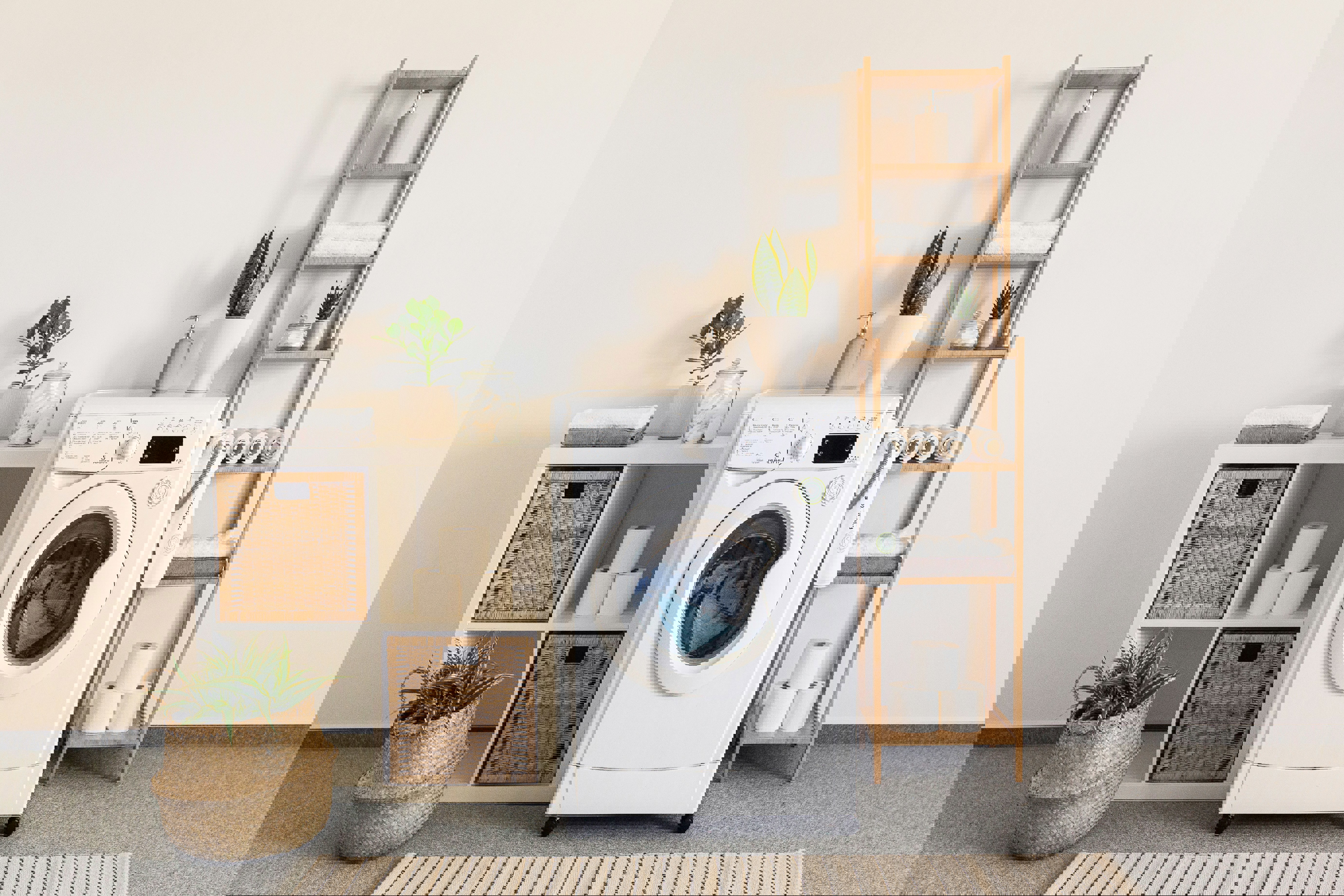 a white washing machine is sitting in a laundry room