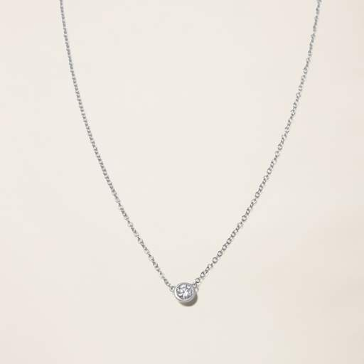 a necklace with a single diamond on a chain