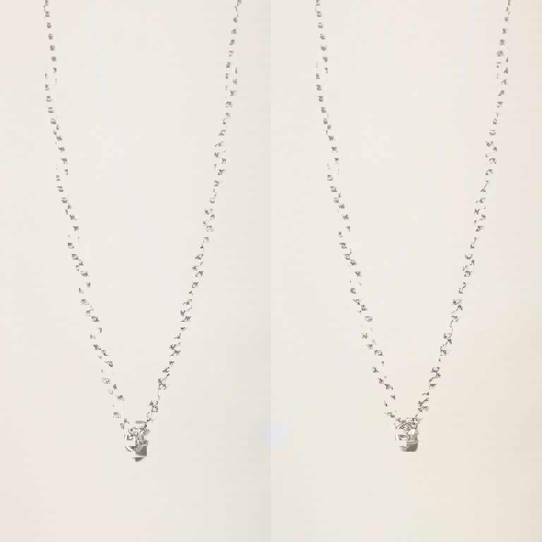 a necklace with a single diamond on a chain