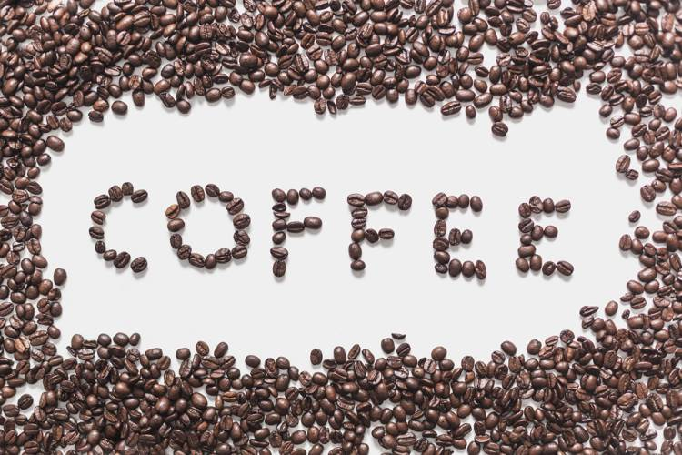 the word coffee is written in coffee beans on a white background
