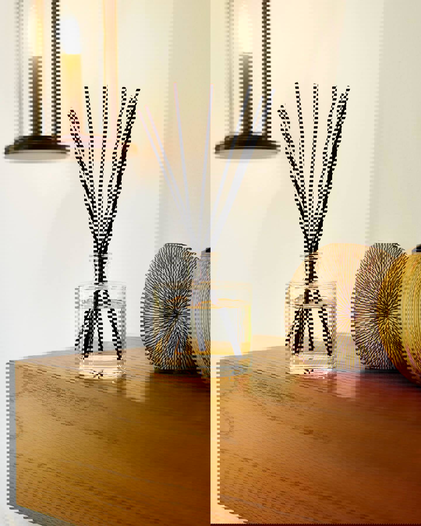 a bottle of reed diffuser sits on a wooden table