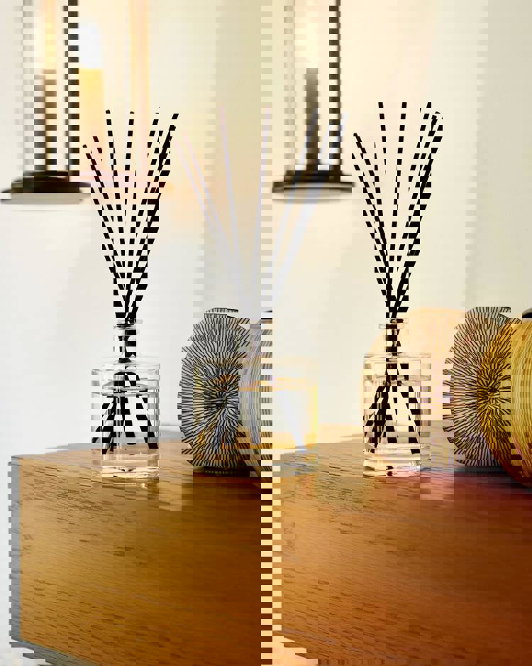 a bottle of reed diffuser sits on a wooden table