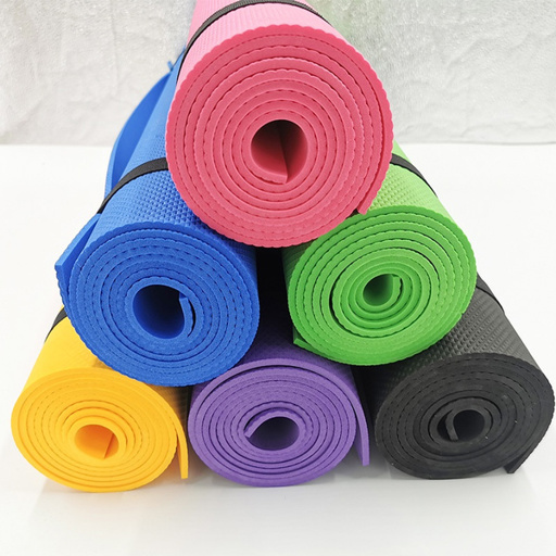 a bunch of different colored yoga mats stacked on top of each other