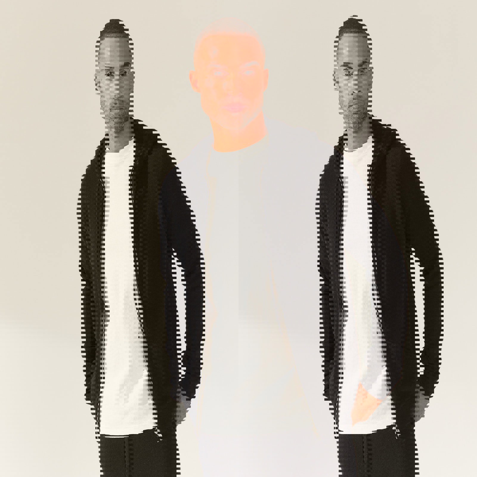 a man wearing a black hoodie and a white shirt