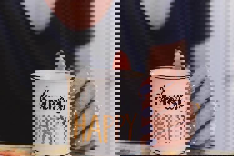 a woman is holding a mug that says choose happy