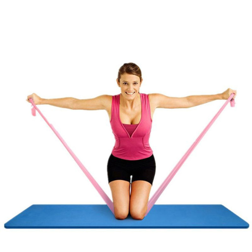 a woman in a pink tank top is kneeling on a blue mat holding a pink resistance band