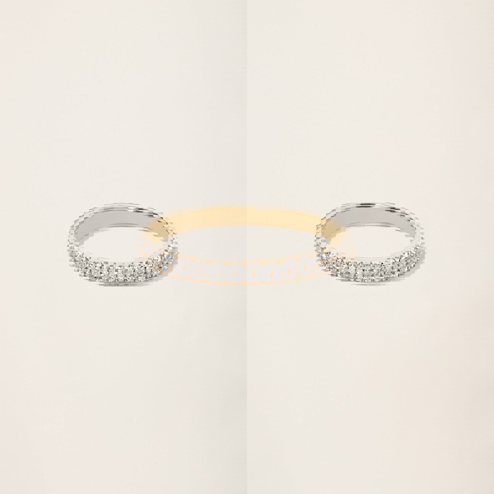 a yellow gold ring with diamonds on a white background