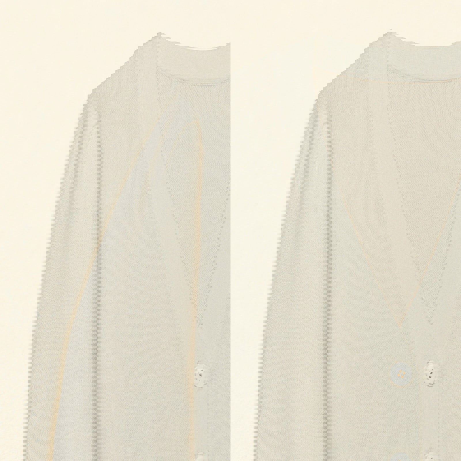 a close up of a white cardigan with white buttons