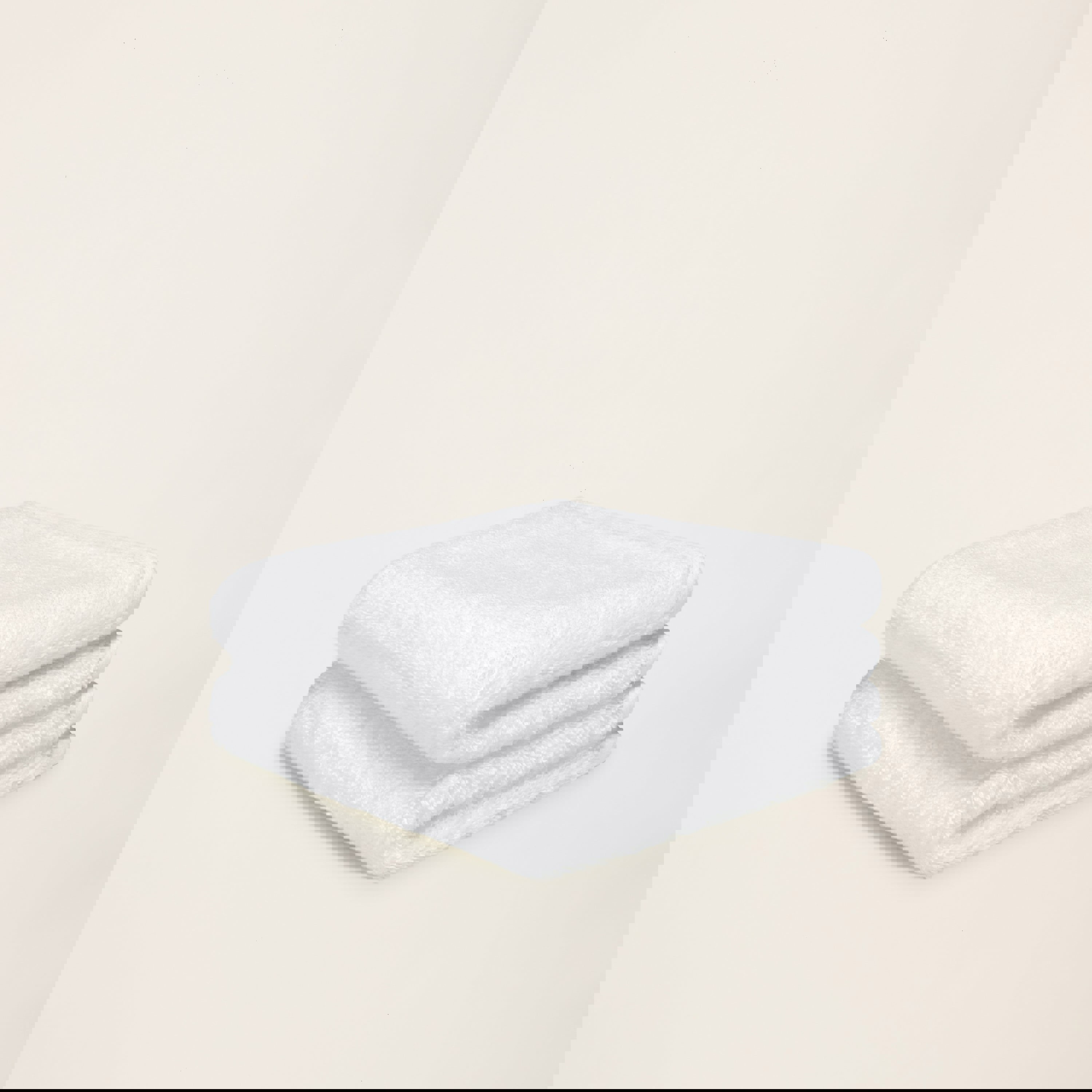 two white towels are stacked on top of each other