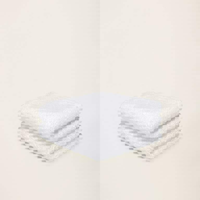 two white towels are stacked on top of each other