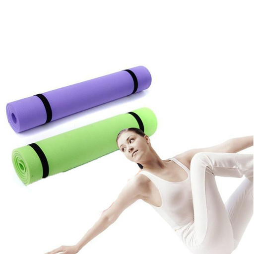 a woman is laying on a green yoga mat next to a purple yoga mat