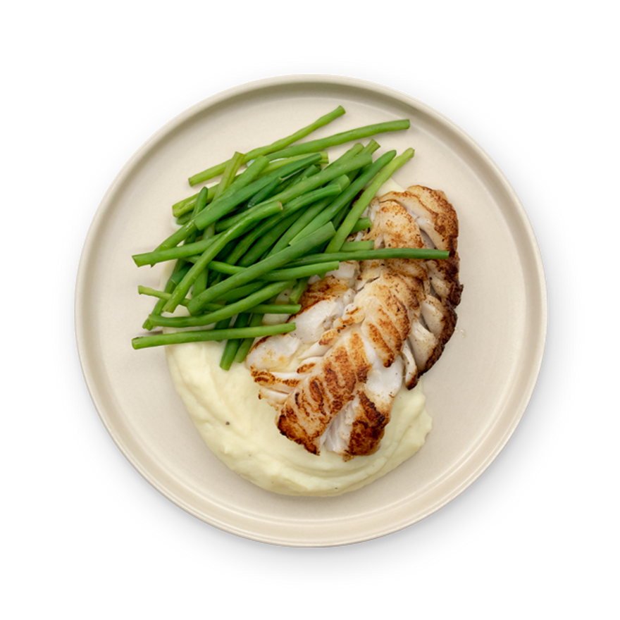 a plate of food with mashed potatoes and green beans on a white background