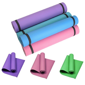 four different colored yoga mats are stacked on top of each other