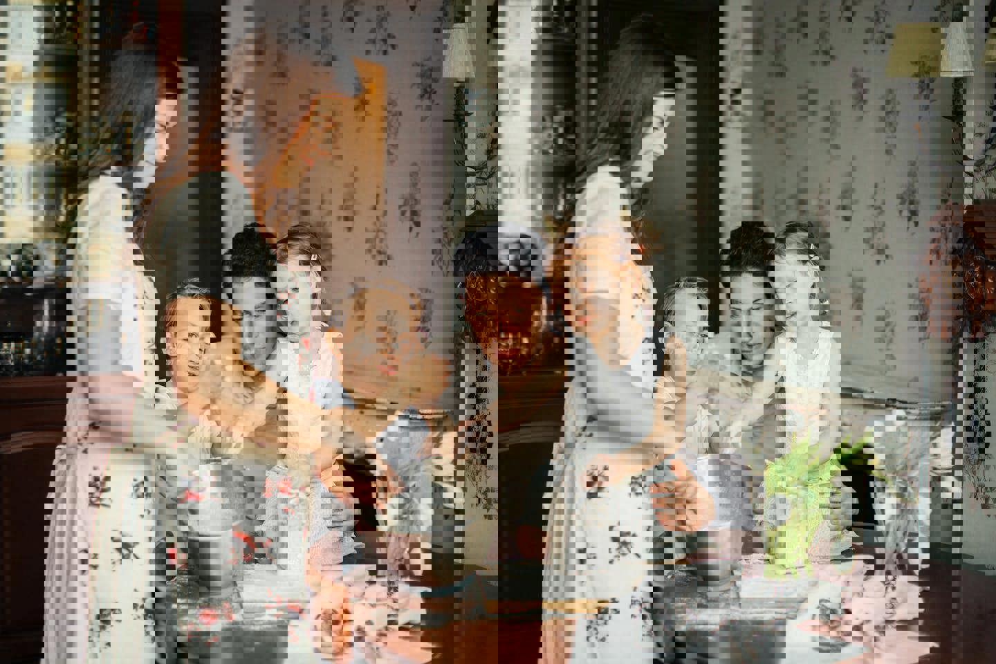 a family is preparing food together in the kitchen