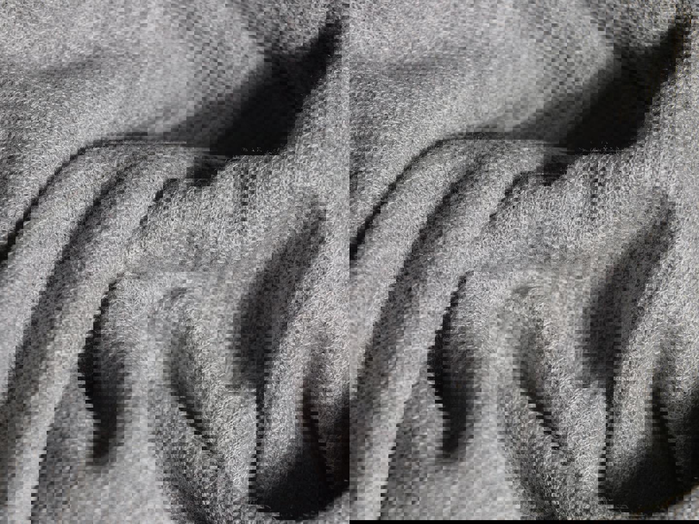 a close up of a gray blanket with a pattern on it