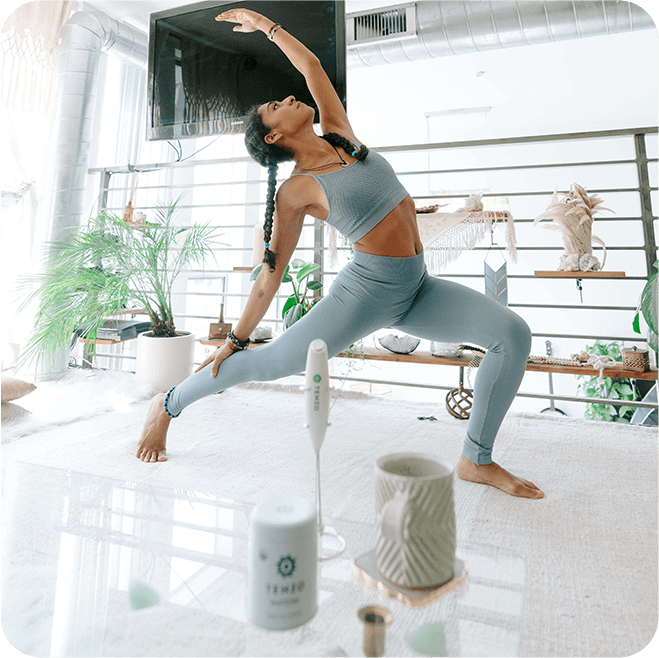 a woman is doing a yoga pose in a living room