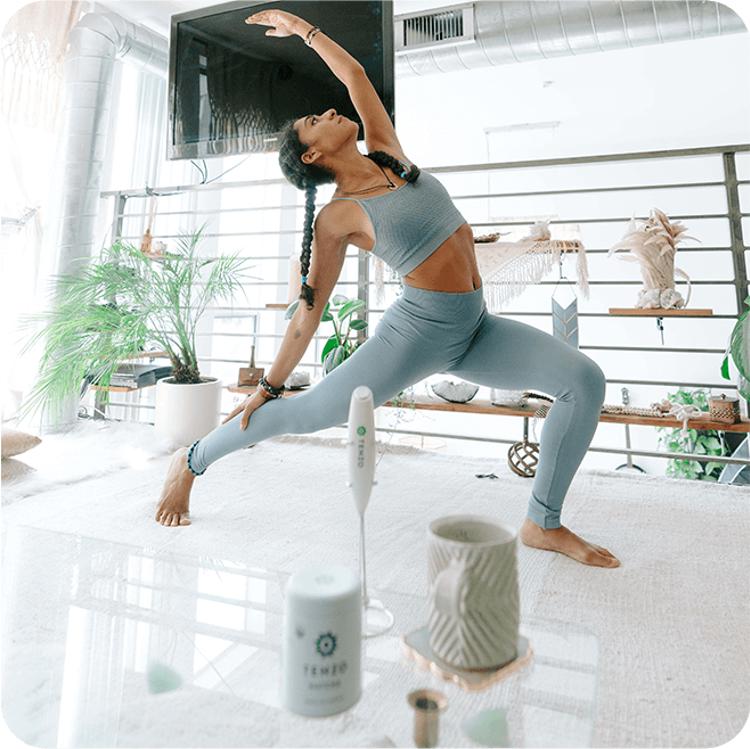 a woman is doing a yoga pose in a living room
