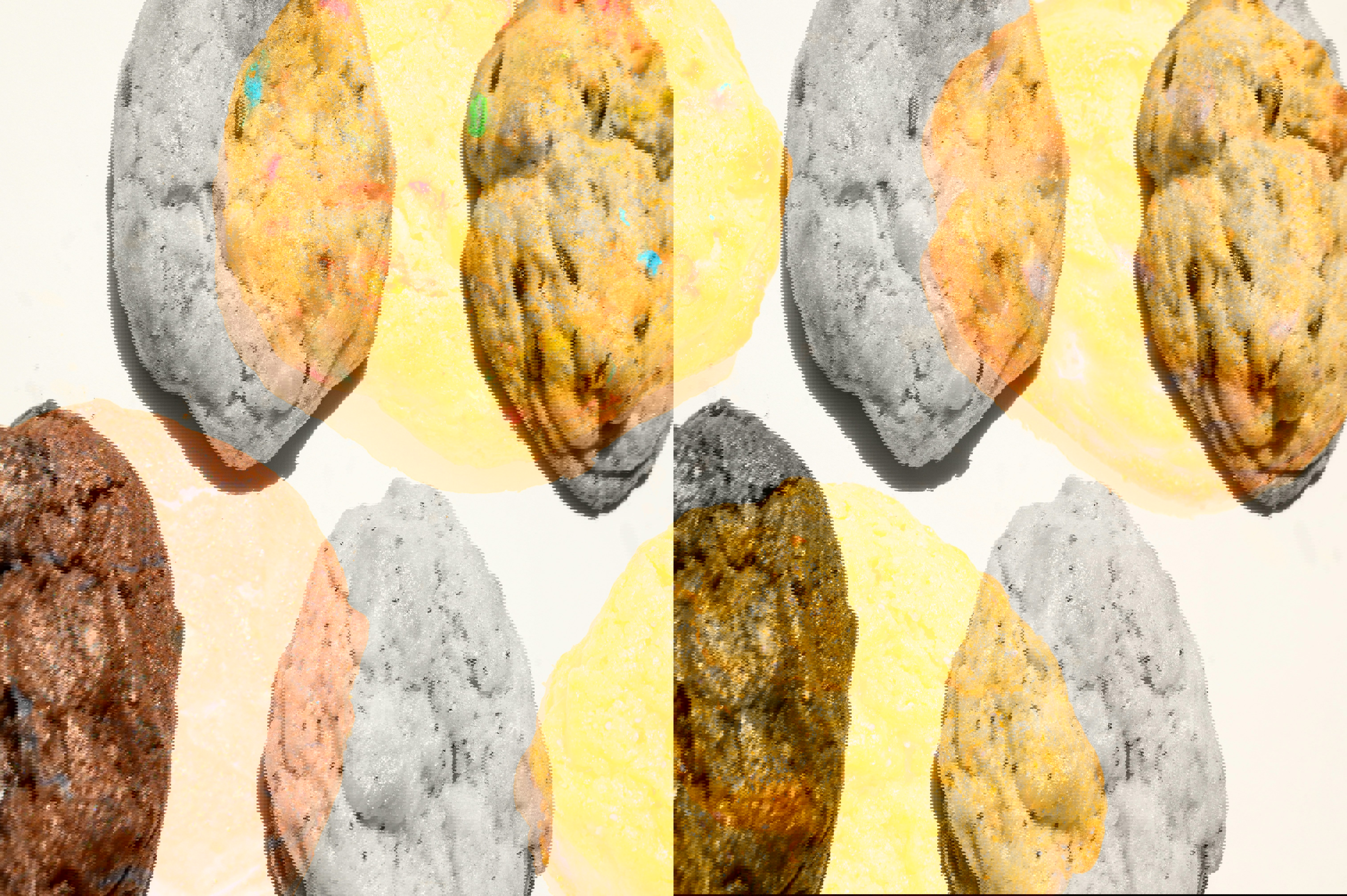 four different types of cookies are on a white surface