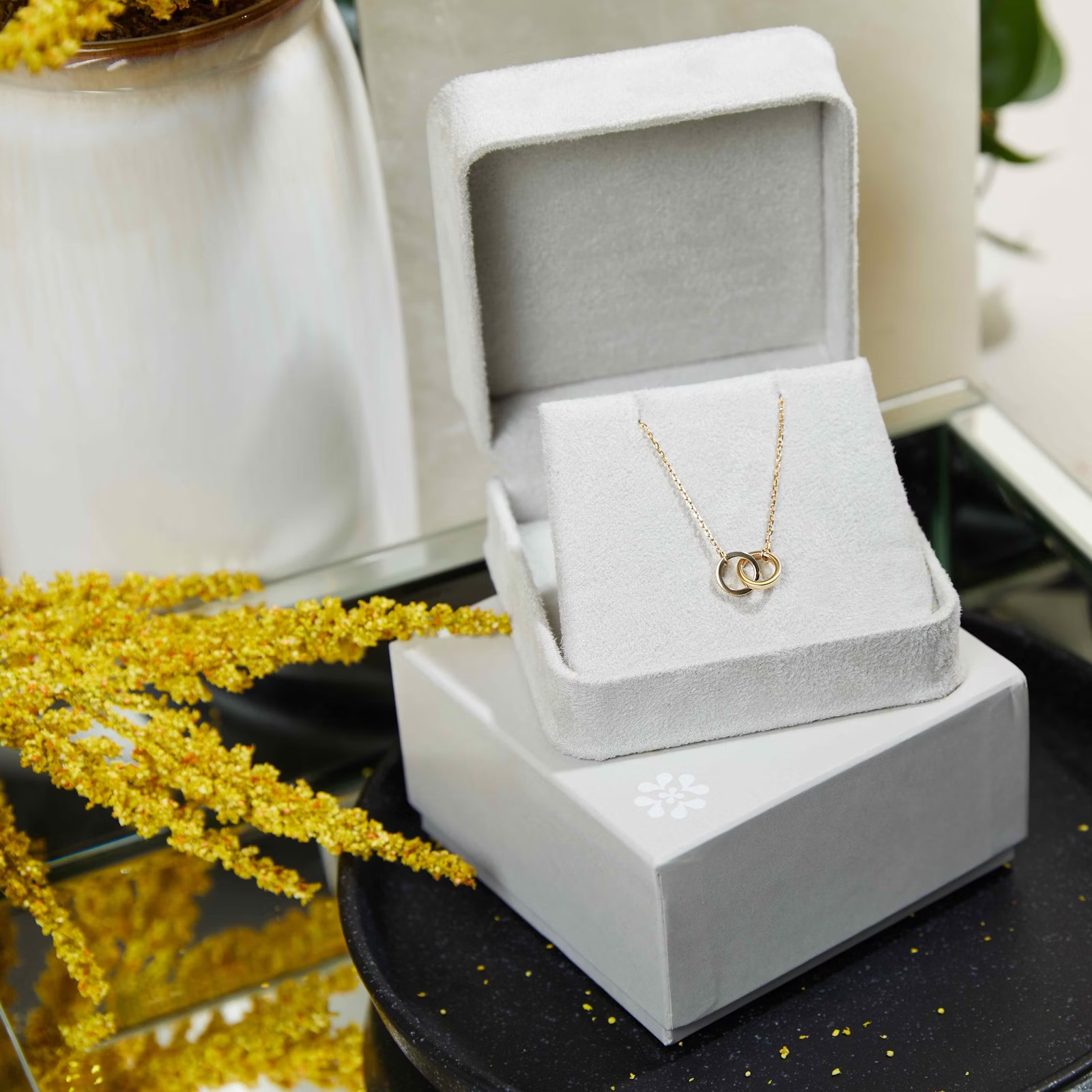 a necklace is sitting in a white box on a table