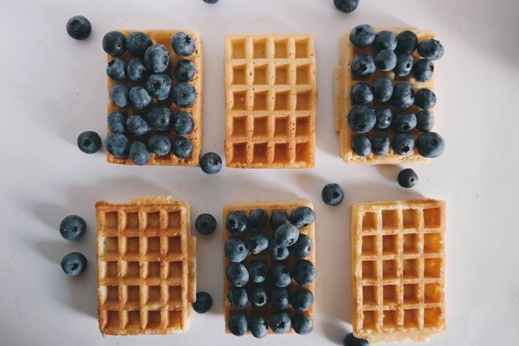a row of waffles with blueberries on them