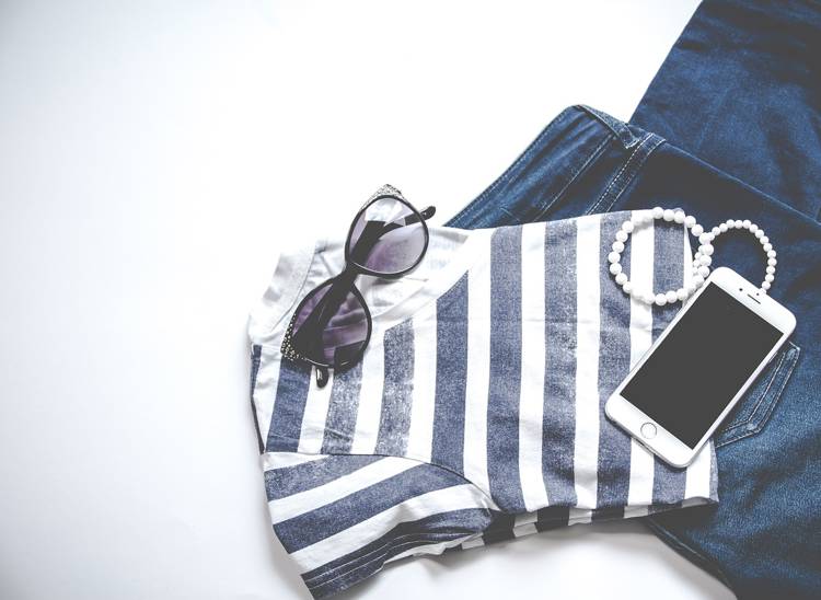 a striped shirt with sunglasses and a cell phone on it