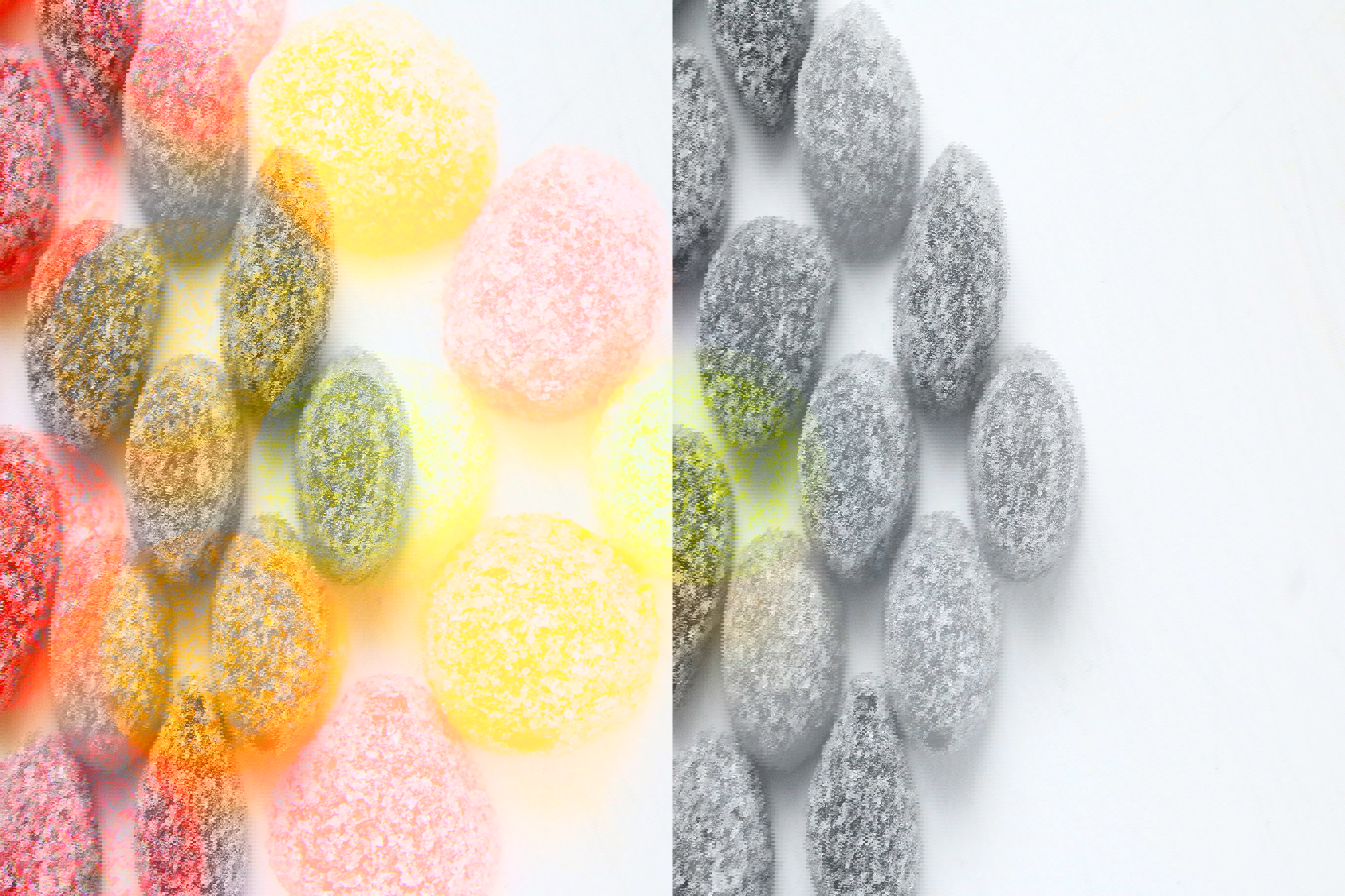 a bunch of different colored gummy candies on a white surface