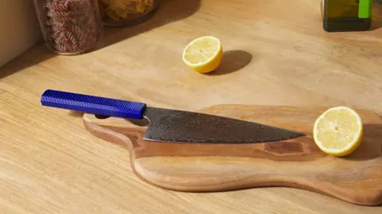 japanese knife on a cutting board with sliced lemon halves