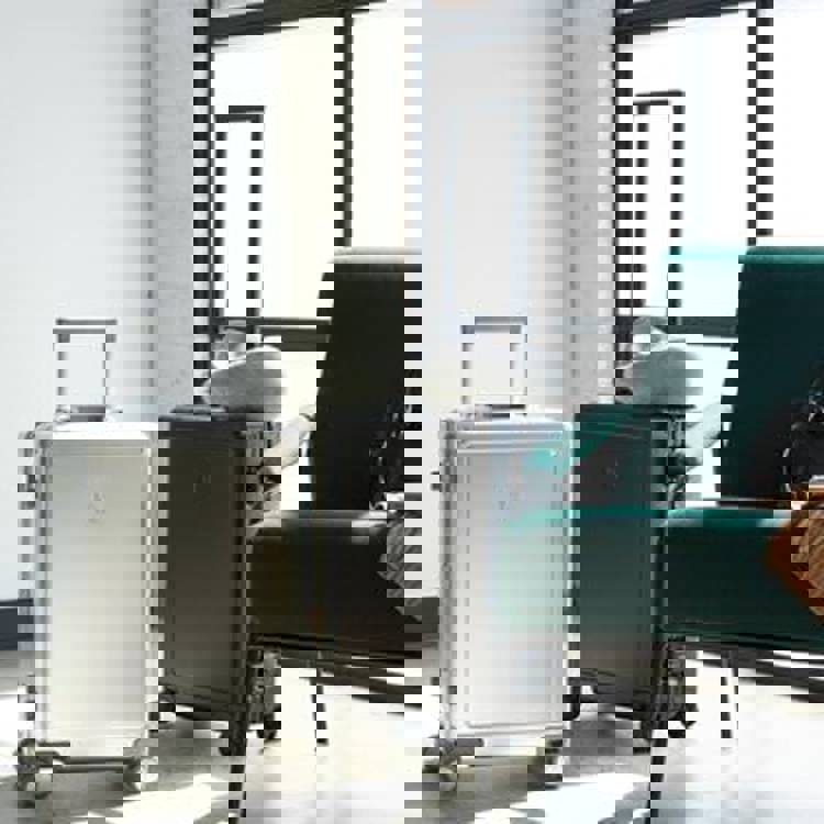 two suitcases are sitting next to each other in a room next to a chair