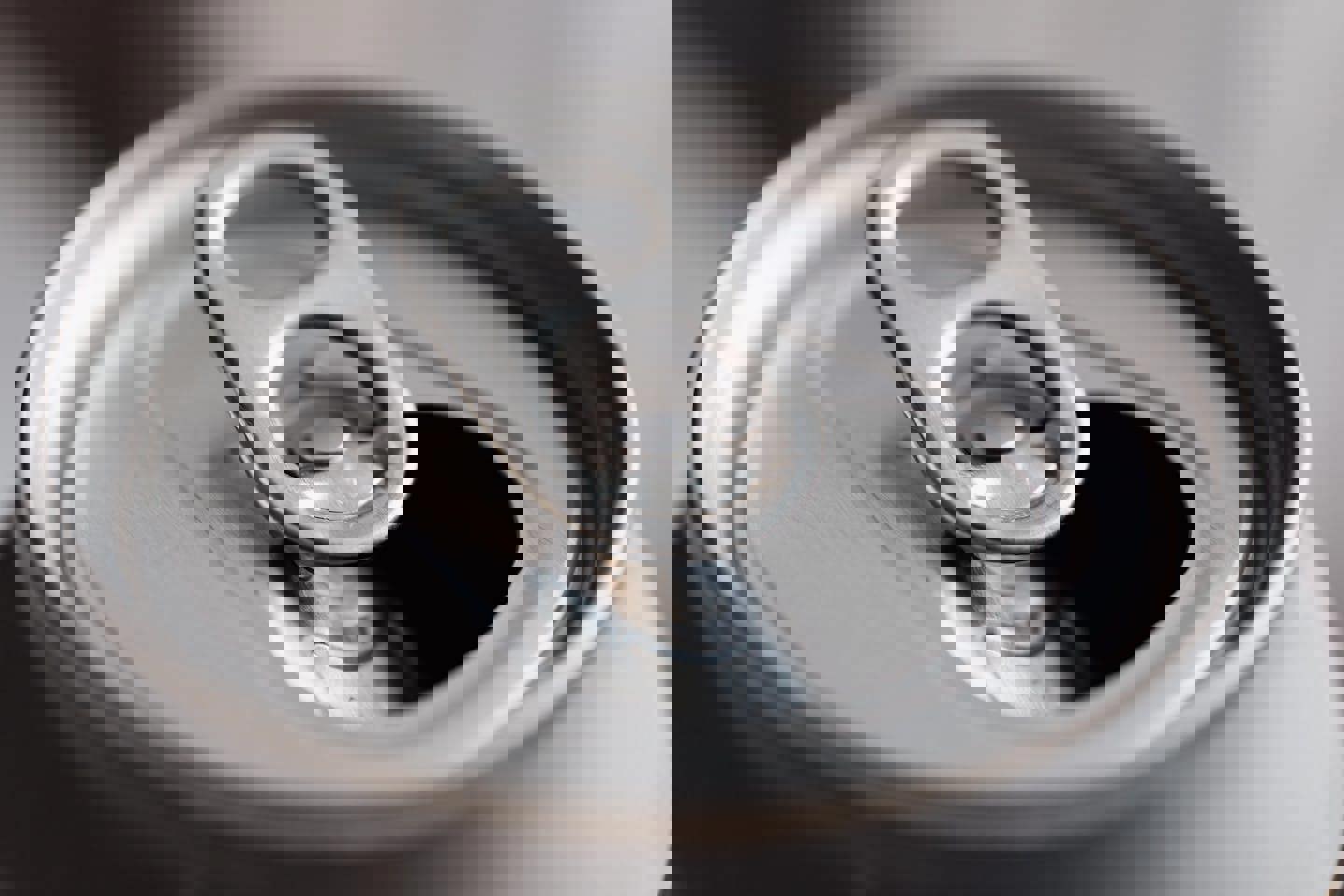 a close up of an open soda can on a table