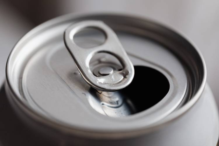 a close up of an open soda can on a table