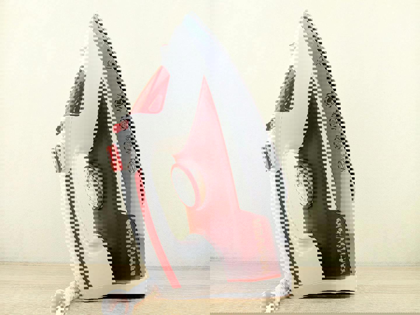 a hoover iron sits on a wooden table