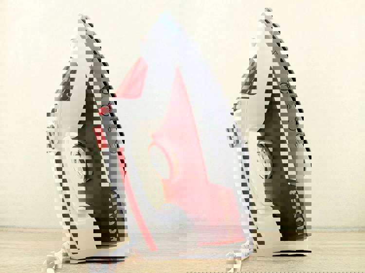 a hoover iron sits on a wooden table