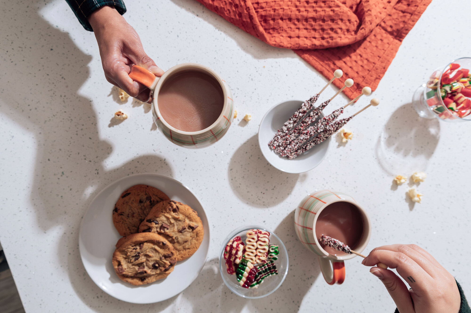 a person is dipping a cookie into a cup of hot chocolate