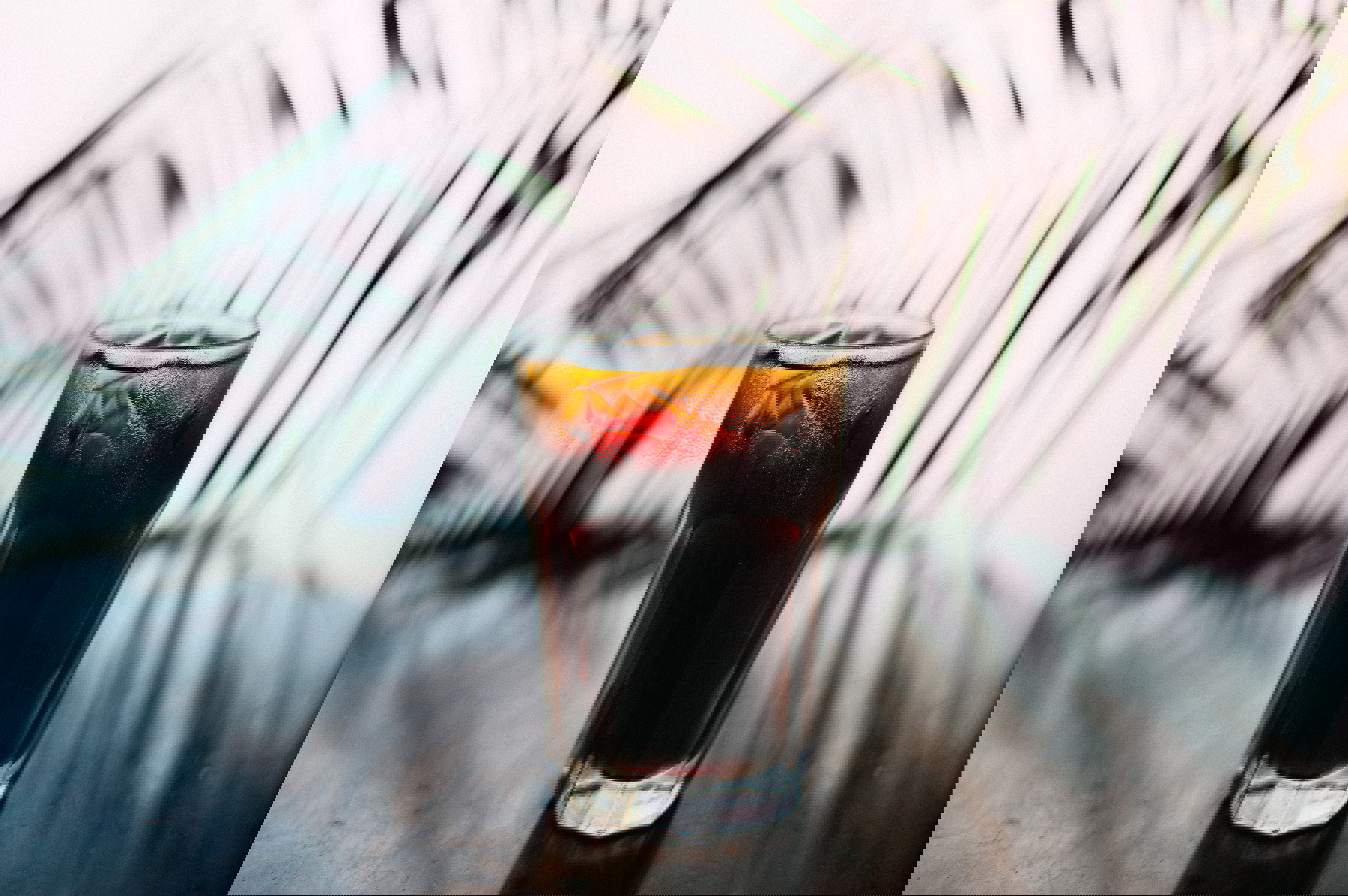 a tall glass of iced coffee on a table