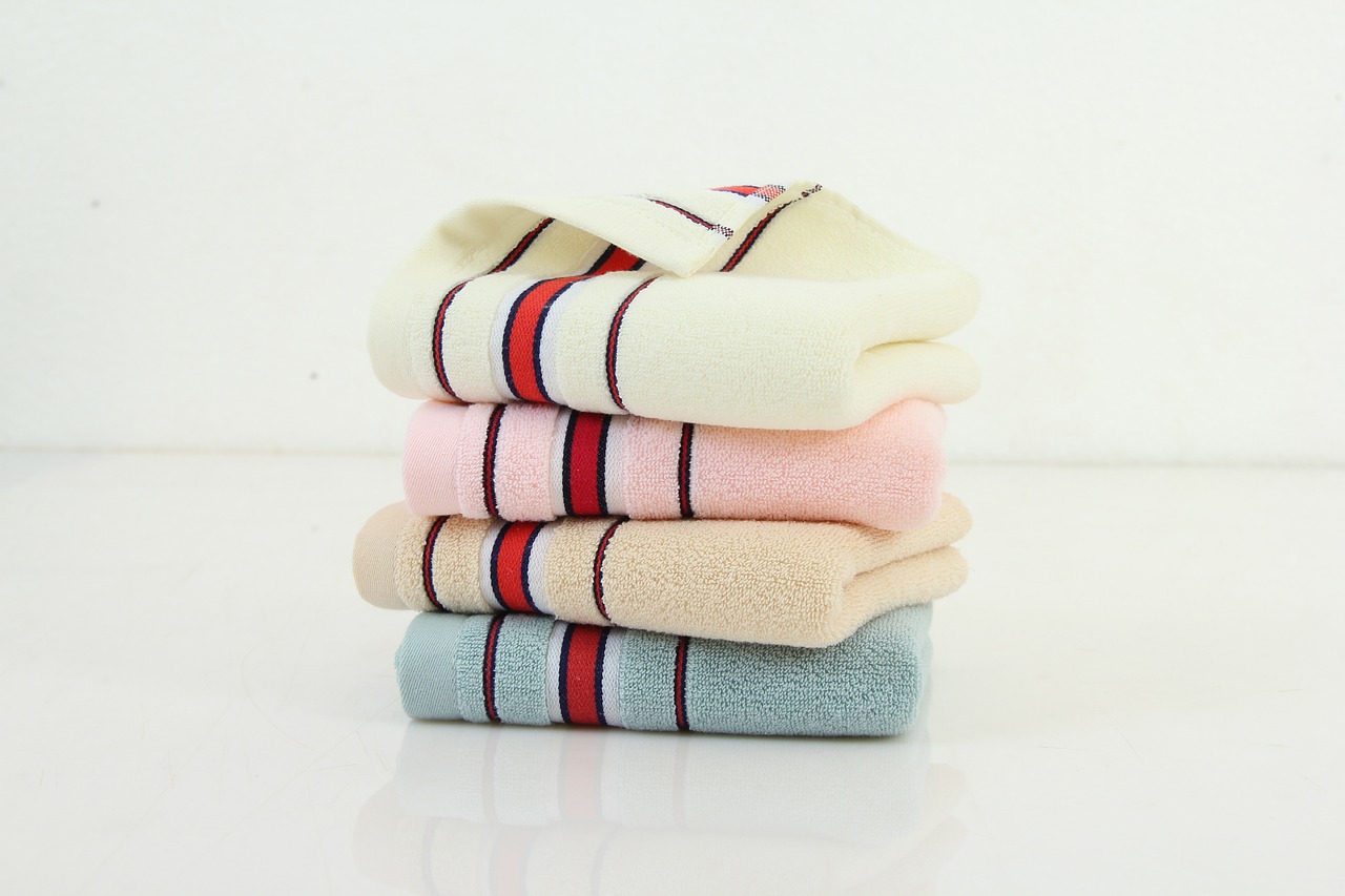 four striped towels are stacked on top of each other