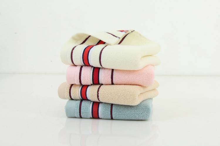 four striped towels are stacked on top of each other